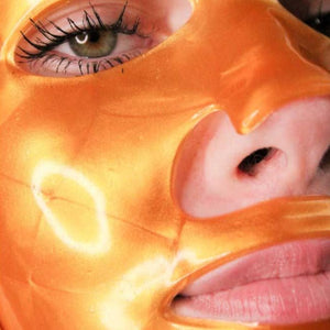 
                  
                    Load image into Gallery viewer, Close up of gold mask on womans face
                  
                