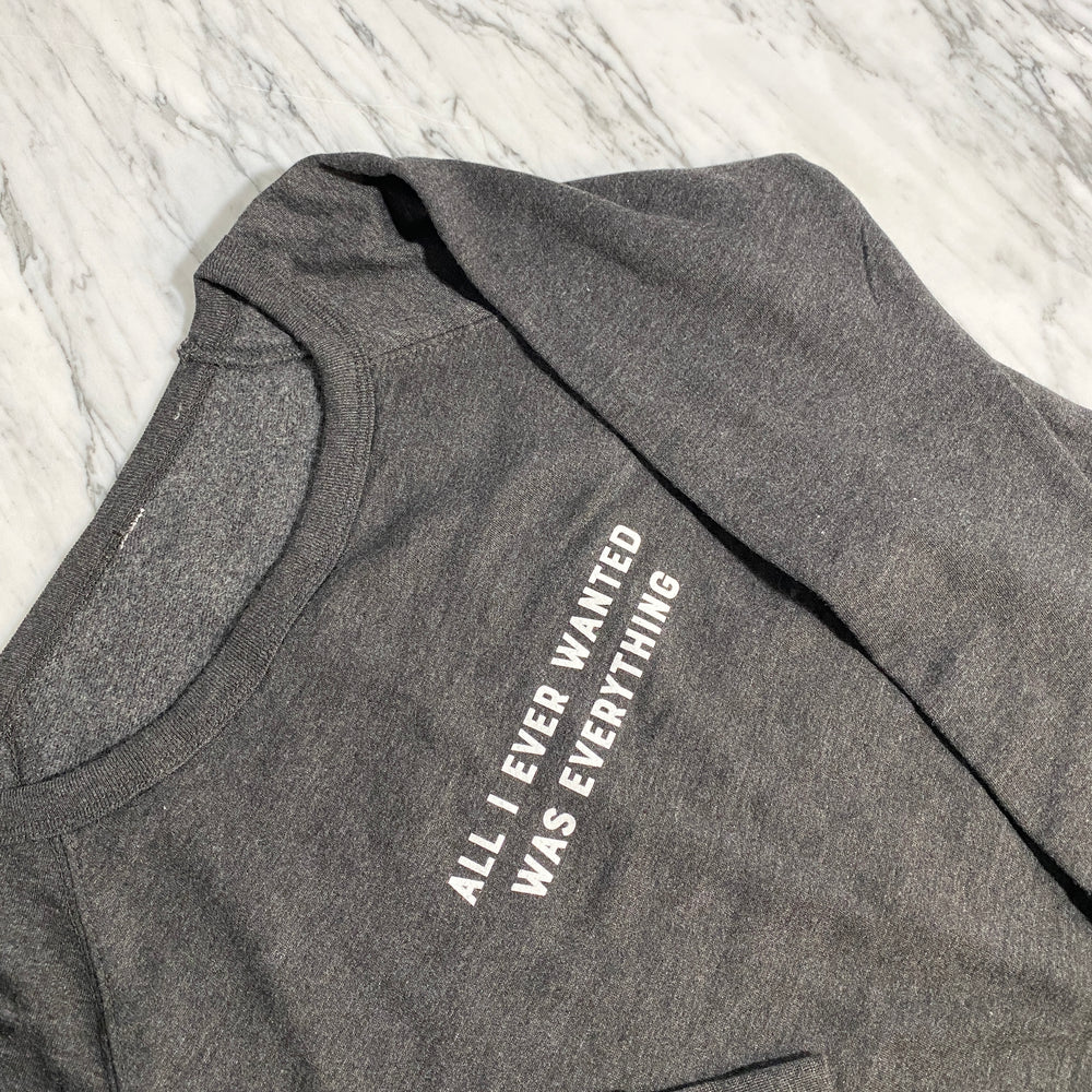 Sweatshirt with text reading All I ever wanted was everything on marble background