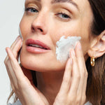 Woman applying Microdermabrasion scrub to face