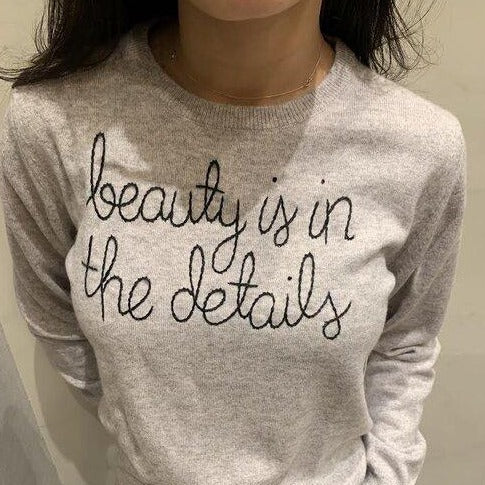 
                  
                    Load image into Gallery viewer, Grey sweater reading beauty in the details
                  
                
